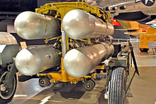 Four silver B28FI nuclear bombs in a rack ready for loading into an aircraft.